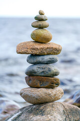 Pyramid of stones. Unstable balance of stone objects. Idyllic state of nature.