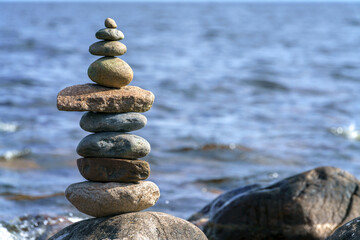 Pyramid of stones. Unstable balance of stone objects. Idyllic state of nature.