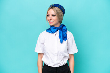 Airplane blonde stewardess woman isolated on blue background looking side