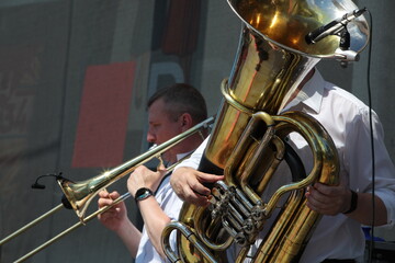 Obraz premium Musicians playing brass musical instruments golden tuba close-up