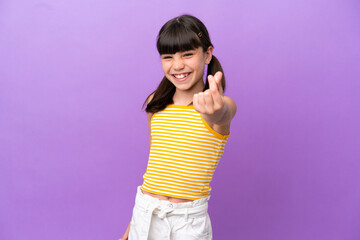 Little caucasian kid isolated on purple background making money gesture