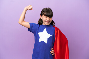 Little kid isolated on purple background in superhero costume and doing strong gesture