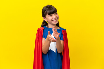 Little super hero kid isolated on purple background applauding after presentation in a conference