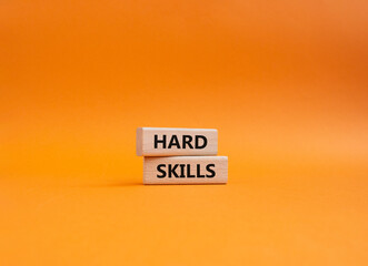 Hard skills symbol. Wooden blocks with words Hard skills. Beautiful orange background. Business and Hard skills concept. Copy space.