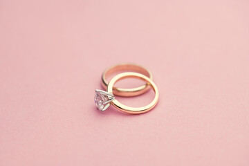 Engagement and Wedding Rings on Pink Background