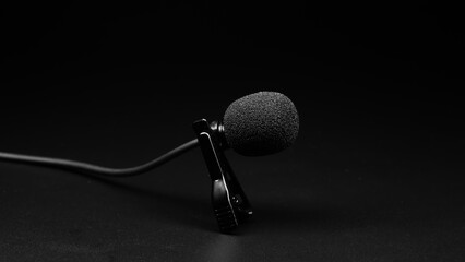 small lavalier microphone close-up on a black background