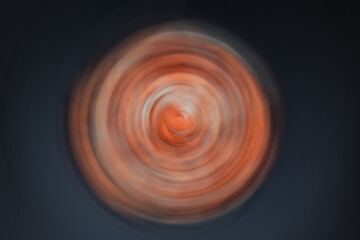 Abstract dynamic motion background in blur. Red-white circles in the dark.