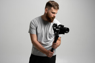Professional content creator with a dslr camera on 3-axis gimbal stabilizer. Filmmaking, videography, hobby and creativity concept.