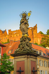 Old fountain and statue of Madonna, Virgin Merry with her sun in front of ancient medieval...