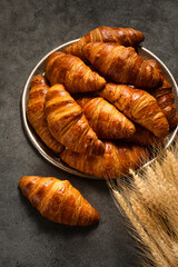 crispy croissants on a tray on a gray background