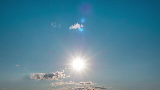 Bright sun light ray flare n sunbeam shining through colorful cumulus cloud on Beautiful sunny pastel blue sky in tropical summersun shining on summer hozizon in vibrant sunlight 4k b-roll TimeLapse