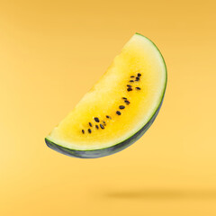 Fresh raw yellow watermelon falling in the air