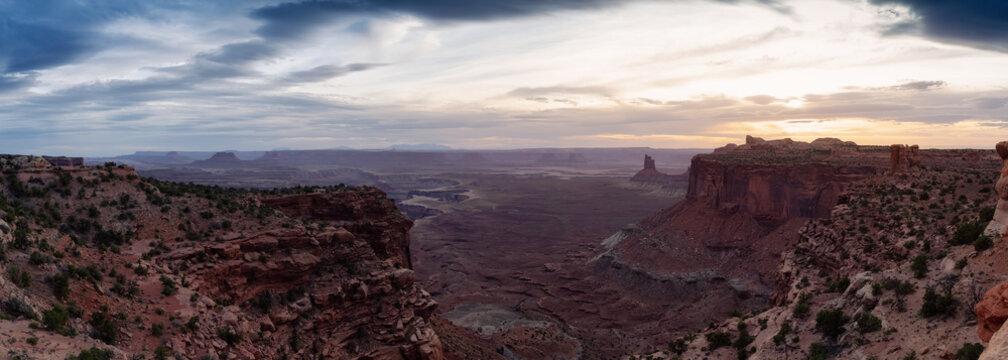 Scenic Panoramic View of American Landscape and Red Rock Mountains in Desert Canyon. Cloudy Sunset Sky. Canyonlands National Park. Utah, United States. Nature Background Panorama