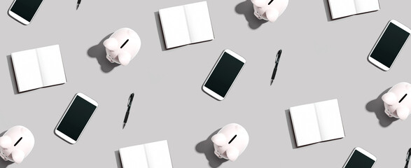 Piggy banks and phones and notebooks - flat lay