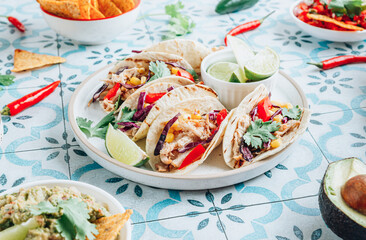 Chicken tacos with red cabbage, tomatoes and corn