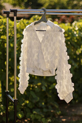 A beautiful stylish summer blouse on a hanger