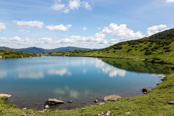 Reflection of the blue sky in the water surface of a mountain lake