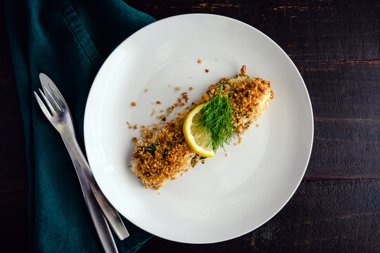 Walnut-Crusted Halibut In Lemon Wine Sauce Viewed From Above: Baked White Fish Fillet Garnished With Fresh Dill And A Slice Of Lemon