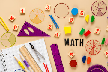 Wooden toy blocks. School supplies, math fractions, pencils, numbers, on beige background. Back to...