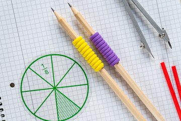 set of tools for drawing. School supplies, math fractions, pencils, numbers, notepad on beige background. Back to school, education concept background	
