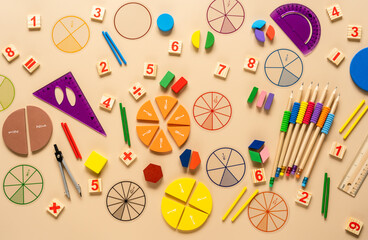 Wooden toy blocks. School supplies, math fractions, pencils, numbers, on beige background. Back to...