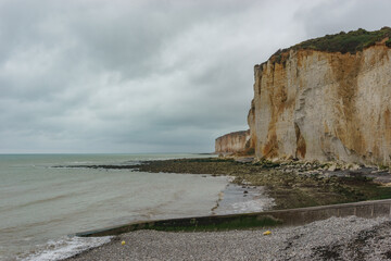 White and brown colored rock cliffs on the Alabaster Coast on a cloudy summer day, Plage des Grandes Dalles, Normandy, France