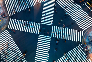 Traffic and people cross a busy intersection in Ginza, Tokyo