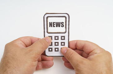 In the hands of a person is a cardboard model of a telephone with an inscription on the screen - NEWS