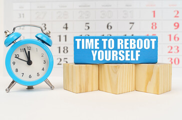 Against the background of the calendar, an alarm clock and a blue block with the inscription -Time...
