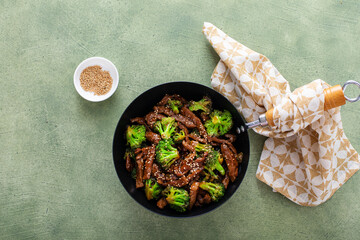 Beef and broccoli stir fry in a small wok