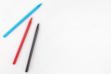 Colored pens lie on a white background concept. Education. Background. School. Isolated