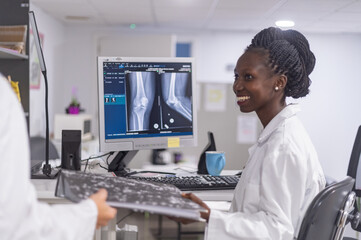 Medical officers consulting each other on x ray results