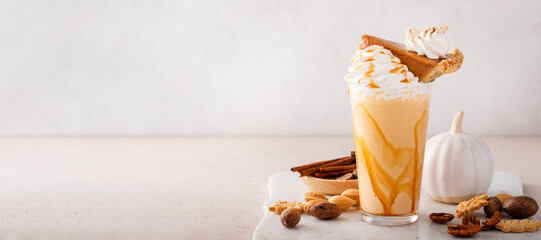 Pumpkin pie milkshake with caramel syrup and whipped cream - obrazy, fototapety, plakaty