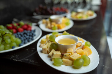 plate with cheese assortment with honey and nuts