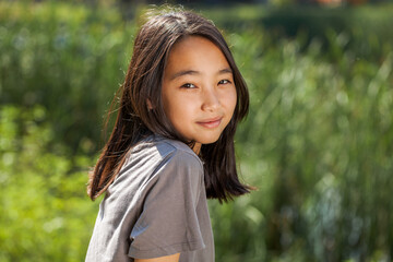 Portrait of a young beautiful girl in summer park