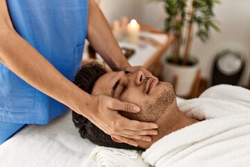 Fototapeta na wymiar Man smiling happy reciving head massage at beauty center.