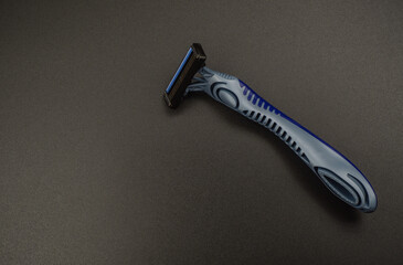 disposable shaving razor on black background