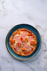 Pizzete. Home baked mini pizzas with ham, cheese. Italian cuisine