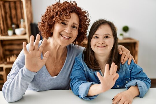 Mature mother and down syndrome daughter at home taking a picture