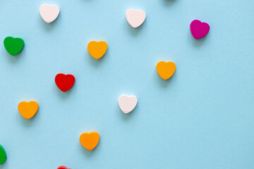 Colored figures in the form of heart on a blue background