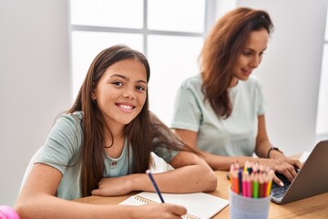 Obraz premium Woman and girl mother and daughter teleworking and drawing at home