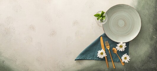 Table setting with chamomile flowers on color background with space for text