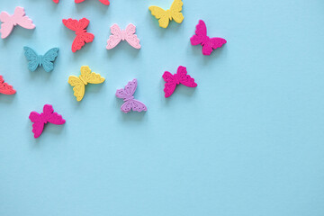 Colored figures in the form of butterfly on a blue background