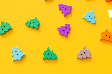 Colored figures in the form of Christmas tree on a yellow background