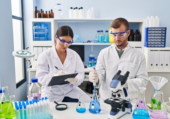 Man and woman scientist partners working at laboratory