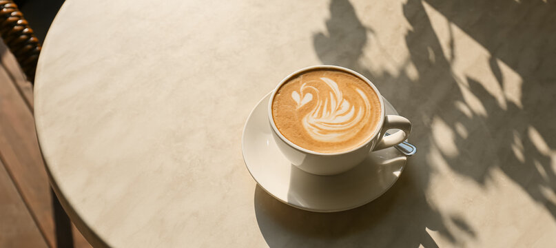 Cup of tasty coffee on table in outdoor cafe