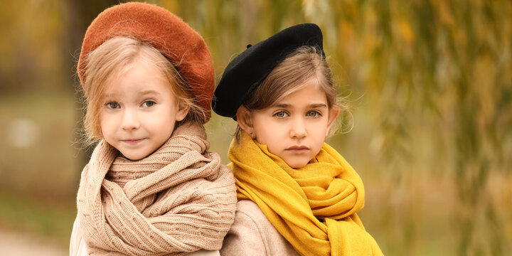 Cute little girls in autumn clothes outdoors