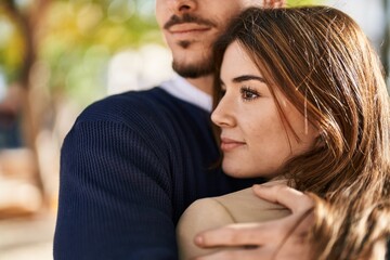 Mand and woman couple hugging each other at park