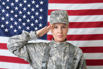 Mature female soldier saluting against USA flag