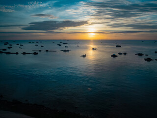 Fototapeta na wymiar Beautiful top view of the sea at sunset with fisher boats in Vietnam